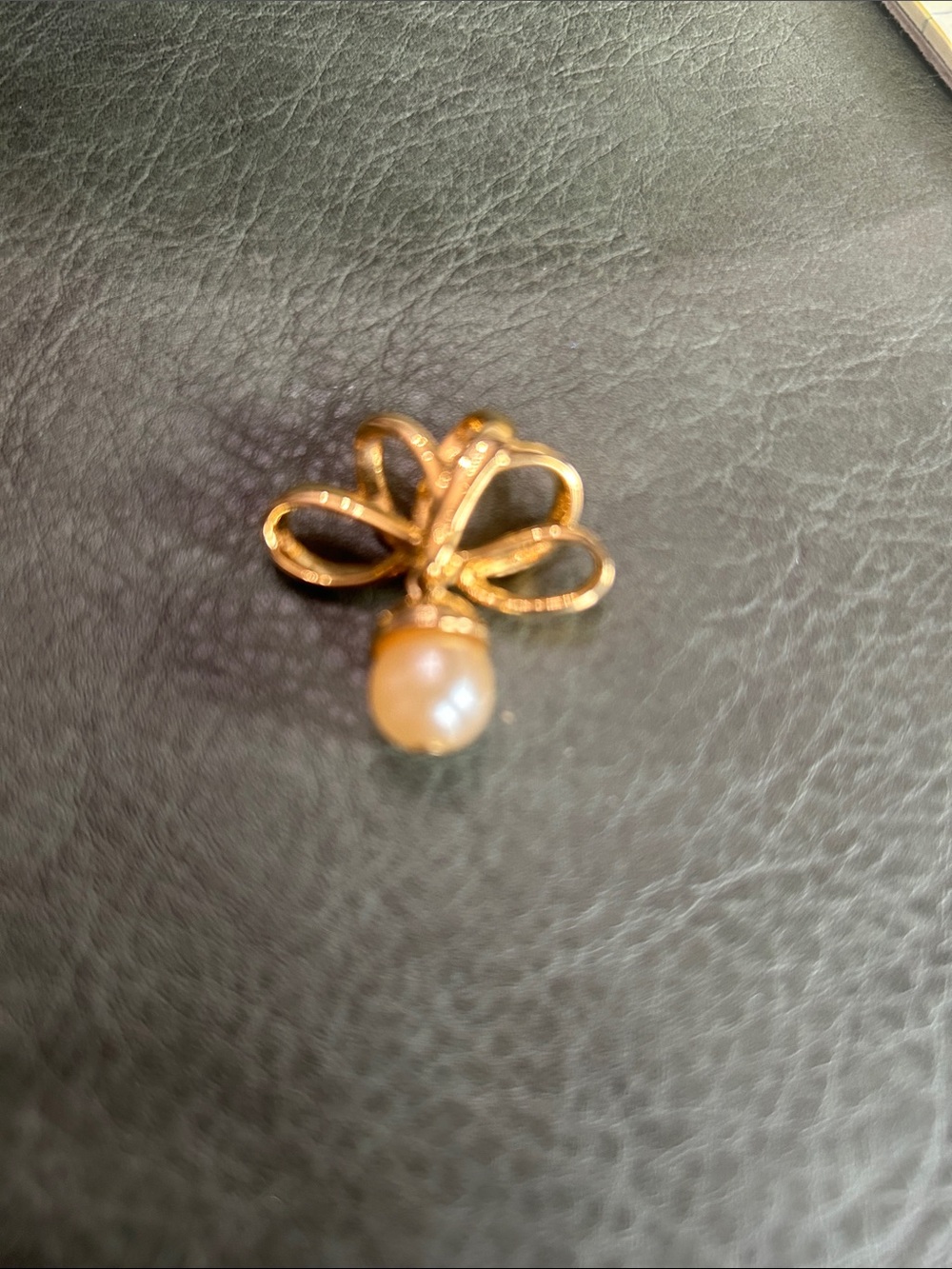 Nolan Miller gold tone bow slider pendant with dangling faux pearl